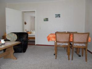 a living room with a table and chairs and a couch at Ferienwohnung in Usedom Town