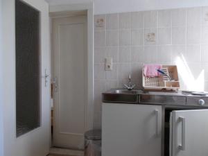 a kitchen with a sink and a counter at Ferienwohnung in Usedom Town +10 photos