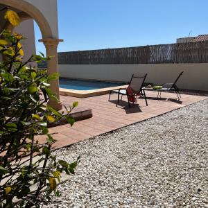 a patio with two chairs and a swimming pool at Villas Monte Jávea - BTB in Jávea