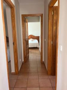 a hallway with two doors and a bed in a room at Villas Monte Jávea - BTB in Jávea