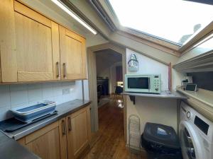 a kitchen with a sink and a microwave on a counter at One bedroom loft apartment central Worcester in Henwick