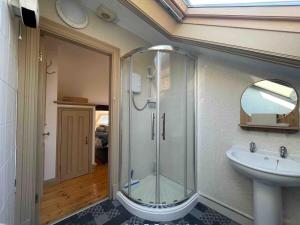 a bathroom with a glass shower and a sink at Worcester City Centre self check-in cosy loft apartment in Henwick