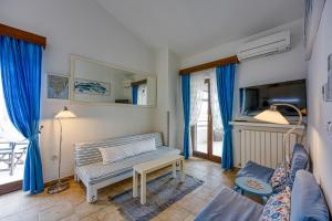 a living room with blue curtains and a couch at Villa Betiga in Mednjan
