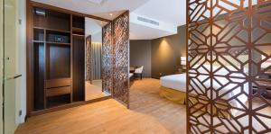a hotel room with a bed and a mirror at DoubleTree Resort by Hilton Hotel Penang in Batu Ferringhi