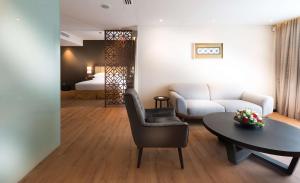 a living room with a couch and a table at DoubleTree Resort by Hilton Hotel Penang in Batu Ferringhi