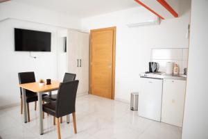 a kitchen and dining room with a table and chairs at Apartmani Link in Požega