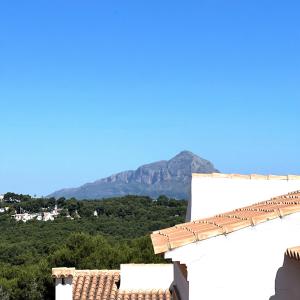 a view of a mountain from a white building at Villas Monte Jávea - BTB in Jávea