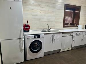 a kitchen with a washing machine and a sink at Blesamemucho - Casa Rural Situada en BLESA in Blesa +21 photos