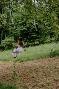 a girl swinging on a swing in a field at Zielony Jeleń - sauna i jacuzzi in Szklarska Poręba +106 photos