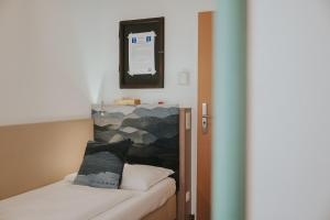 Postel nebo postele na pokoji v ubytování Boutiquehotel Stadthalle