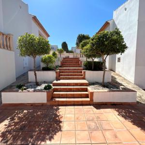 a set of stairs with trees in front of a building at Villas Monte Jávea - BTB in Jávea