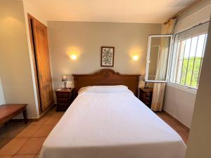 a bedroom with a large white bed and two windows at Villas Monte Jávea - BTB in Jávea +37 photos