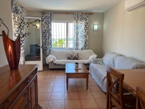 a living room with a couch and a table at Villas Monte Jávea - BTB in Jávea