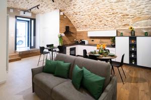 a living room with a couch and a kitchen at Castel Manfredi Apartments in Manfredonia +33 photos