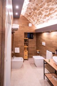 a bathroom with a white toilet and a sink at Castel Manfredi Apartments in Manfredonia