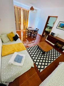 a living room with two beds and a table at Resort Albufeira T1, Praia da Oura in Albufeira