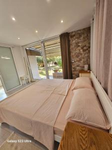 a large bed in a room with a brick wall at RIVA GARDEN relax in Novigrad Istria