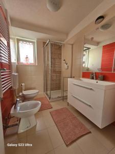 a bathroom with a sink and a toilet and a shower at RIVA GARDEN relax in Novigrad Istria