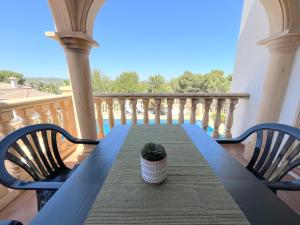 a table on a balcony with a potted plant on it at Villas Monte Jávea - BTB in Jávea