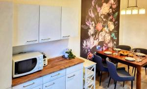 a kitchen with a table with a microwave at HIRSCH FeWo Brocken - Parkplatz - Zentral in Bad Harzburg