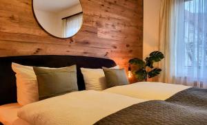 a bedroom with two beds and a mirror on the wall at HIRSCH FeWo Brocken - Parkplatz - Zentral in Bad Harzburg