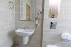 a bathroom with a sink and a mirror at Hotel Domenic FREE PARKING in Plovdiv +40 photos