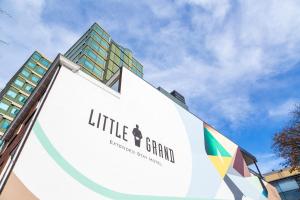 a large white sign with a building in the background at Little Grand in Eindhoven