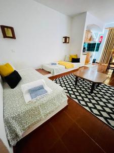 a living room with two beds and a coffee table at Resort Albufeira T1, Praia da Oura in Albufeira +9 photos