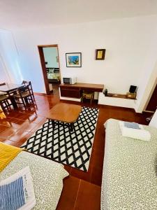 a living room with a table and a couch and a table at Resort Albufeira T1, Praia da Oura in Albufeira