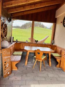 a dining room with a table and a window at Ferienhaus Praschberg in Niederndorferberg +36 photos