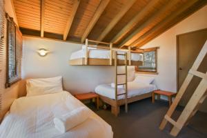 a bedroom with two beds and a bunk bed at Tambo in Dinner Plain