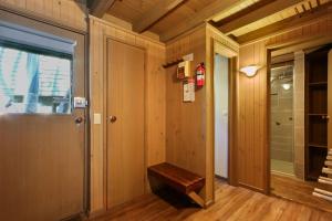 a hallway with a door and a bench in a room at Tambo in Dinner Plain