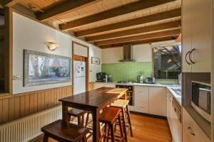 a kitchen with a wooden table and chairs at Tambo in Dinner Plain