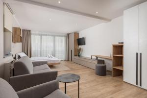 a living room with a couch and a bed at Belinda apartments with balcony in Opatija
