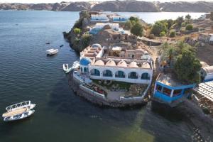 an aerial view of a large house in the water at Miskaa Nubian House in Naj‘ Tinjār