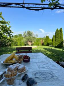 a table with plates of food on top at Tiny house 1 - Imanje Terzic in Podgorica