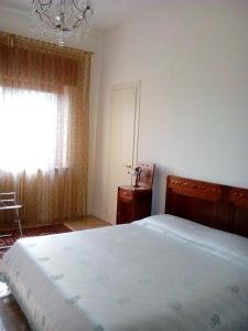 En eller flere senge i et værelse på Villa Osmanthus