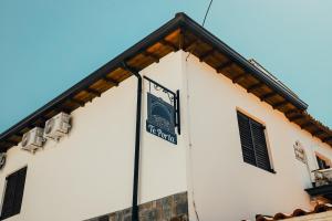 a white building with a sign on the side of it at Te Porta in Berat