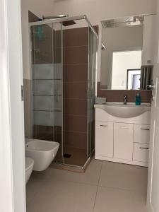 a bathroom with a shower and a sink and a toilet at Nuovo appartamento in Florence