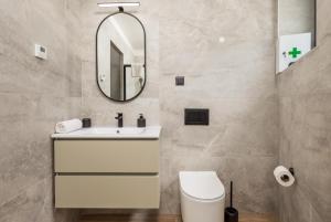 a bathroom with a white sink and a mirror at Belinda apartments with balcony in Opatija +60 photos