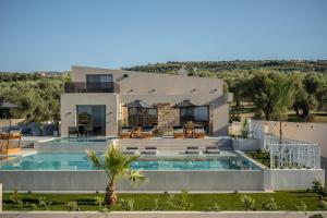 an aerial view of a house with a swimming pool at Bliss Villas in Rethymno Town