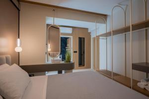a bedroom with a bed and a mirror at Bliss Villas in Rethymno Town