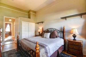 a bedroom with a bed and a dresser and lamp at Historic Mountain Loft with GREAT Views in Leadville