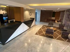 a lobby with chairs and a reception desk in a building at Westin Palace Hotel in Mogi Mirim