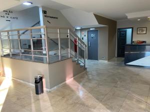a lobby with a staircase and a stair case at Westin Palace Hotel in Mogi Mirim