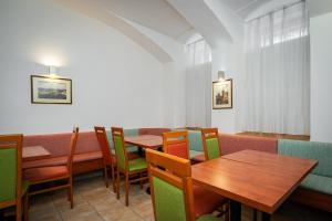 a dining room with tables and chairs in a restaurant at City Central De Luxe in Prague