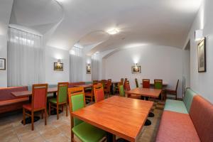 a restaurant with wooden tables and colorful chairs at City Central De Luxe in Prague
