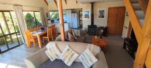 a living room with a couch and a table at Moananui Lodge in Purau