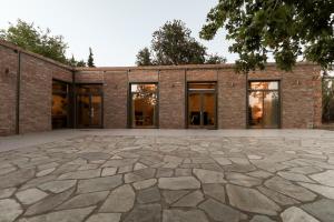 a stone patio in front of a brick building at Just Barrett in Rovies