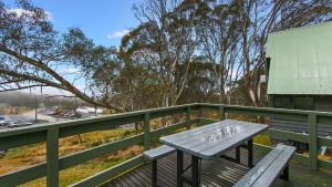 a picnic table sitting on a wooden deck at The Cubby in Dinner Plain